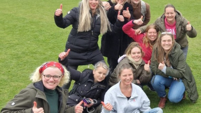 Groepje acteurs op het grasveld in een stadion